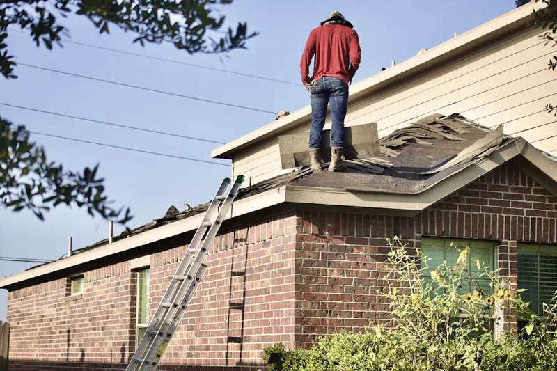 Professional roofer working on a residential roof in Mt. Tabor
